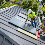 Metal roof contractors installing durable roofing on a Toronto home, showcasing teamwork and quality materials.